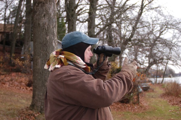 Tom Funke counts sandhill cranes as they come in to roost during the evening crane count, Photo by: Howard Meyerson