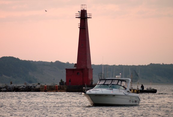 Anglers fish for salmon just after dawn off Muskegon. Ports from Muskegon south will be watched closely once the state reduces salmon stocking in 2013. Photo:  Howard Meyerson