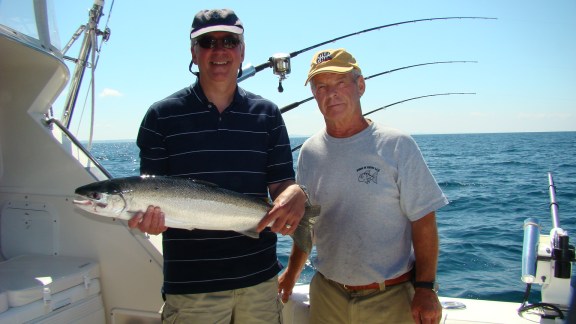 Michigan's Gov. Rick Snyder holds up a steelhead caught while fishing with Grinold on his boat, Old Grin. Courtesy photo.