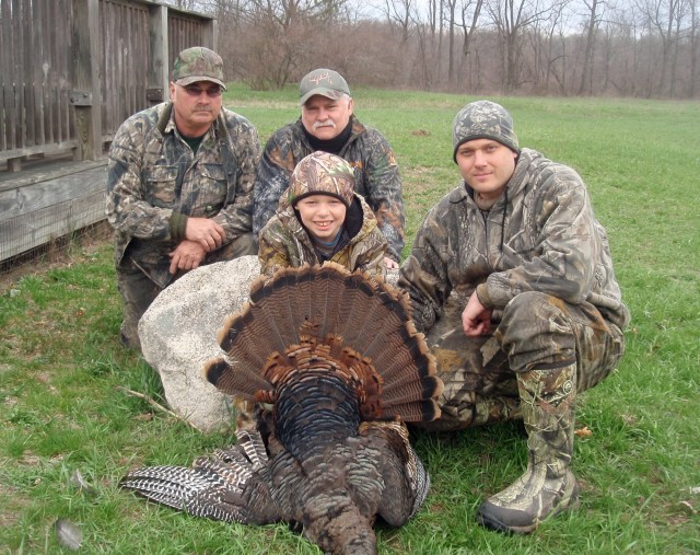 Cameron Edgerton shot this 14-pound turkey while being mentored by his uncle, John German. Behind them are guides Bruce Waterman, left, and Dennis Neibarger. Photo: Courtesy.