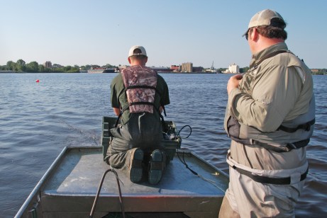 DNR summer staffer, Tanner Sommerfeld (left)  and Brandon Harris set nets on Muskegon Lake in an attempt to collect sturgeon for tagging.  Photo: Howard Meyerson