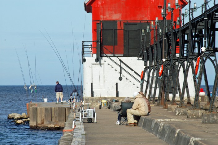 Anglers on the Grand Haven pier wait for a bite. Some say fishing has been been slow, but some larger salmon were caught earlier this spring. Photo: Howard Meyerson