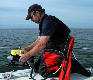 John Hanson prepares to lower the ROV into Lake Michigan to look for the wreck.  Photo: Howard Meyerson