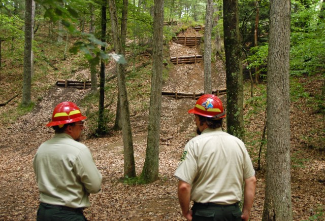 Baldwin district acting ranger, Chris Frederick (left) and trail coordinator, Dave Jaunese (right) look over ORV damage restoration work underway in the Manistee National Forest where illegal hill climbs created erosion. Photo: Howard Meyerson