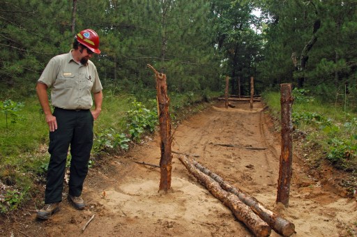 Dave Jaunese looks over work underway to close an illegal road created by rogue ORV riders. Photo: Howard Meyerson