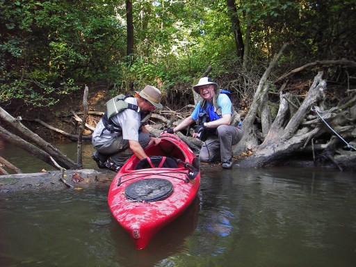 Don Harrell (right) helps John Mitchell drag his kayak over a tree trunk that was exposed by low water levels on the river. Photo: Howard Meyerson