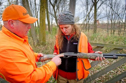 Trish Taylor recieves some instruction from Scott Brosier while shooting some skeet before the hunt. Photo: Dave Kenyon, Michigan DNR.