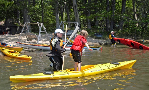 Children learn  balance during a class for kids at the WMCKA Sea Kayaking Symposium. Photo: Howard Meyerson