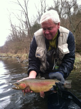 Matt Supinski holds up a rainbow trout caught on Big Spring Creek in Pennsylvania. Photo by:  Jay Nichols