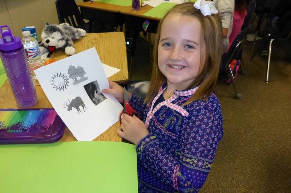 Nine year old Taylor Walker, a 4th grader from Muskegon, enjoys learning about the food web. Photo: Howard Meyerson