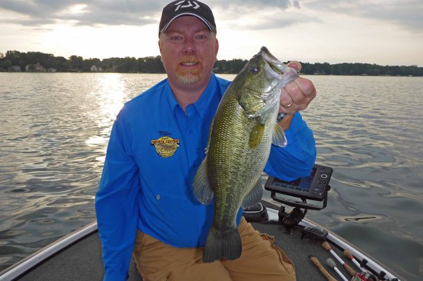 Miles Hanley holds up a 2.5 pound largemouth bass that he landed soon after getting out. Photo: Howard Meyerson
