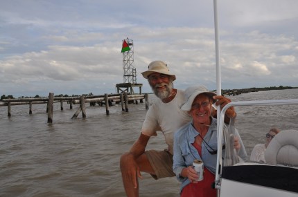  Returning upstream on the river guide's boat, the DeKock's smile and enjoy their first beer in 70 days as they pass the red over green day marker, a coast guard navigation aid marking the channel leading to the Gulf of Mexico, just upstream from the Mile Zero  marker. Photo: Alisun De Kock. 