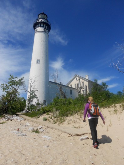 A hiker passing the South Manitou Island Lighthouse, part of Sleeping Bear Dunes National Lakeshore. Photo: Jim DuFresne