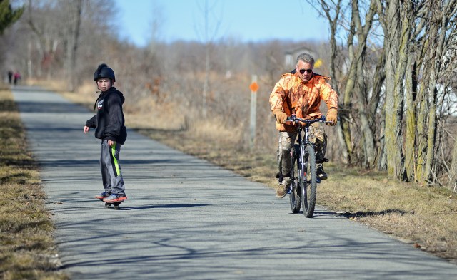 Cyclists and skateboarders regularly use the paved portions of the White Pine Trail. Critics suggest skateboarders and others will not be able to use the segments that will be surfaced with crushed limestone. Photo: Howard Meyerson.